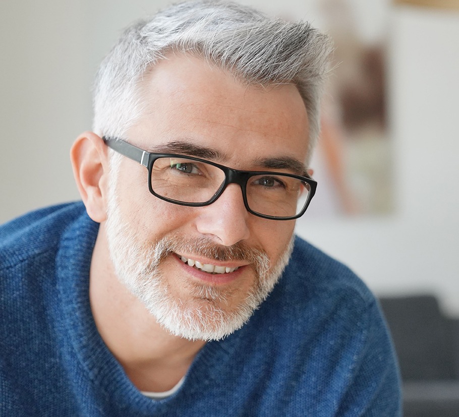 Portrait of smiling man with grey hair and glasses