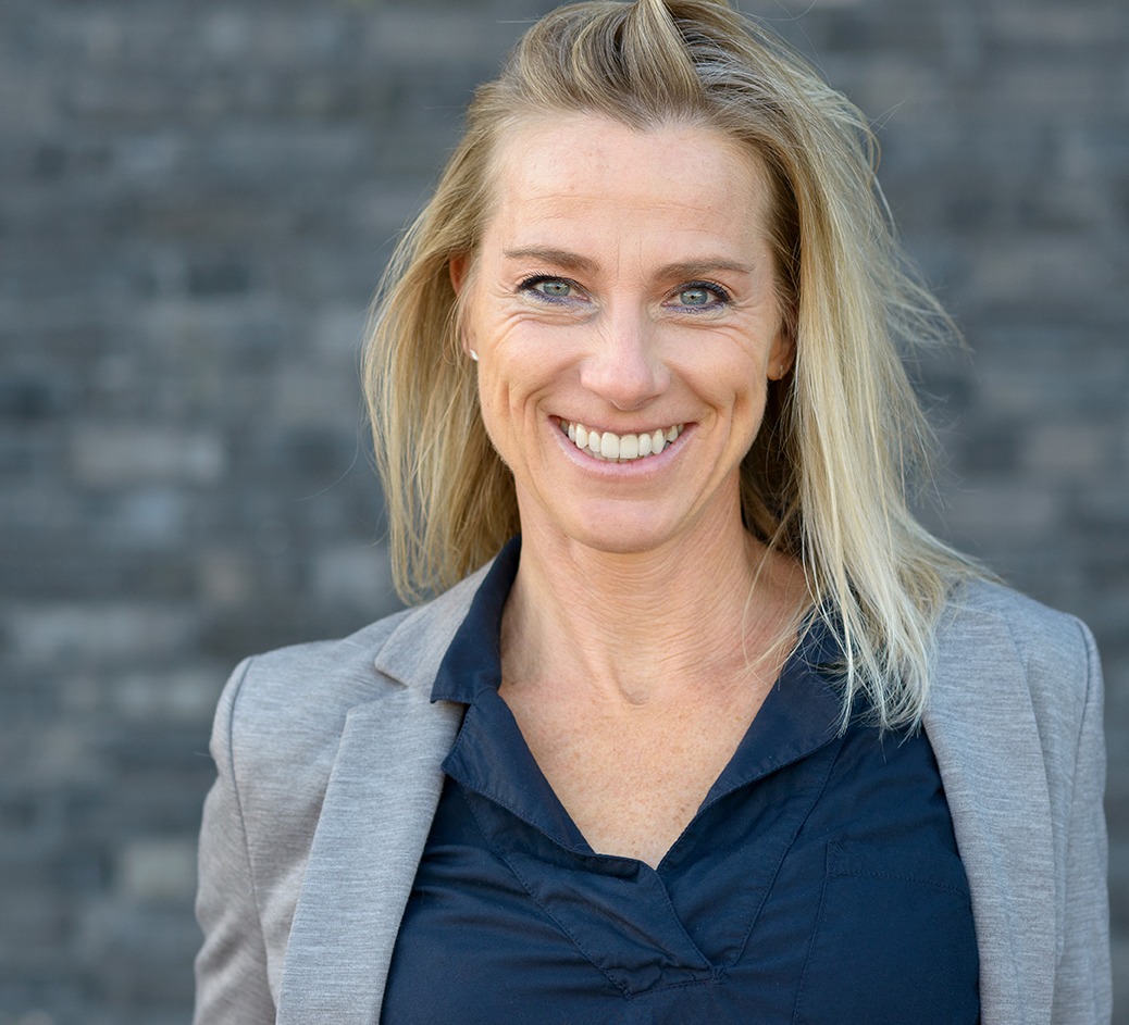 Portrait of smiling woman against grey background